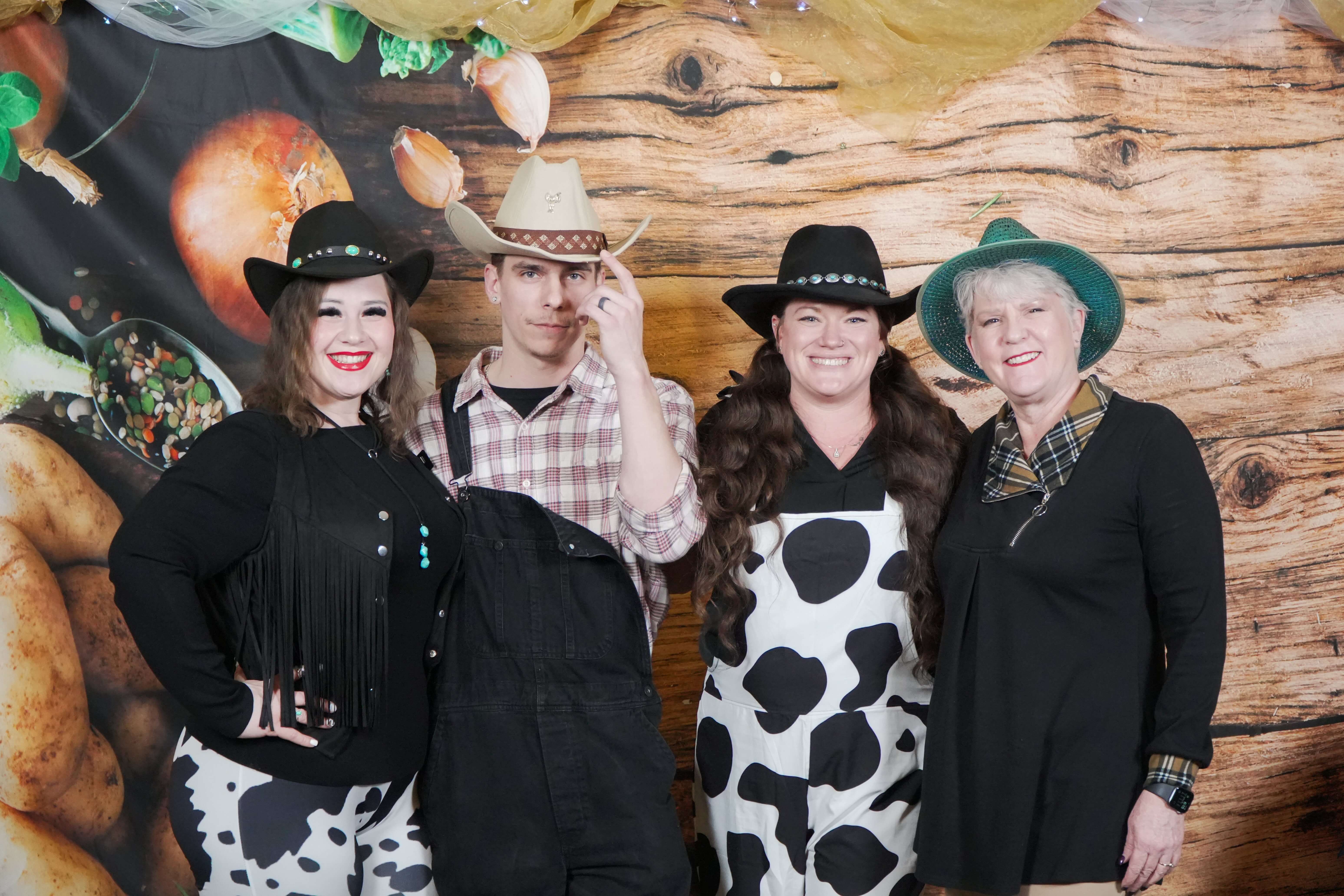 Four guests wearing western-themed outfits at the 2025 Burlington Chamber Awards of Excellence photo booth.