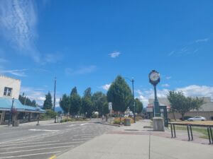 Fairhaven Avenue in Downtown Burlington, Washington, featuring the historic Rotary clock, storefronts, trees, and pedestrian-friendly streetscape.