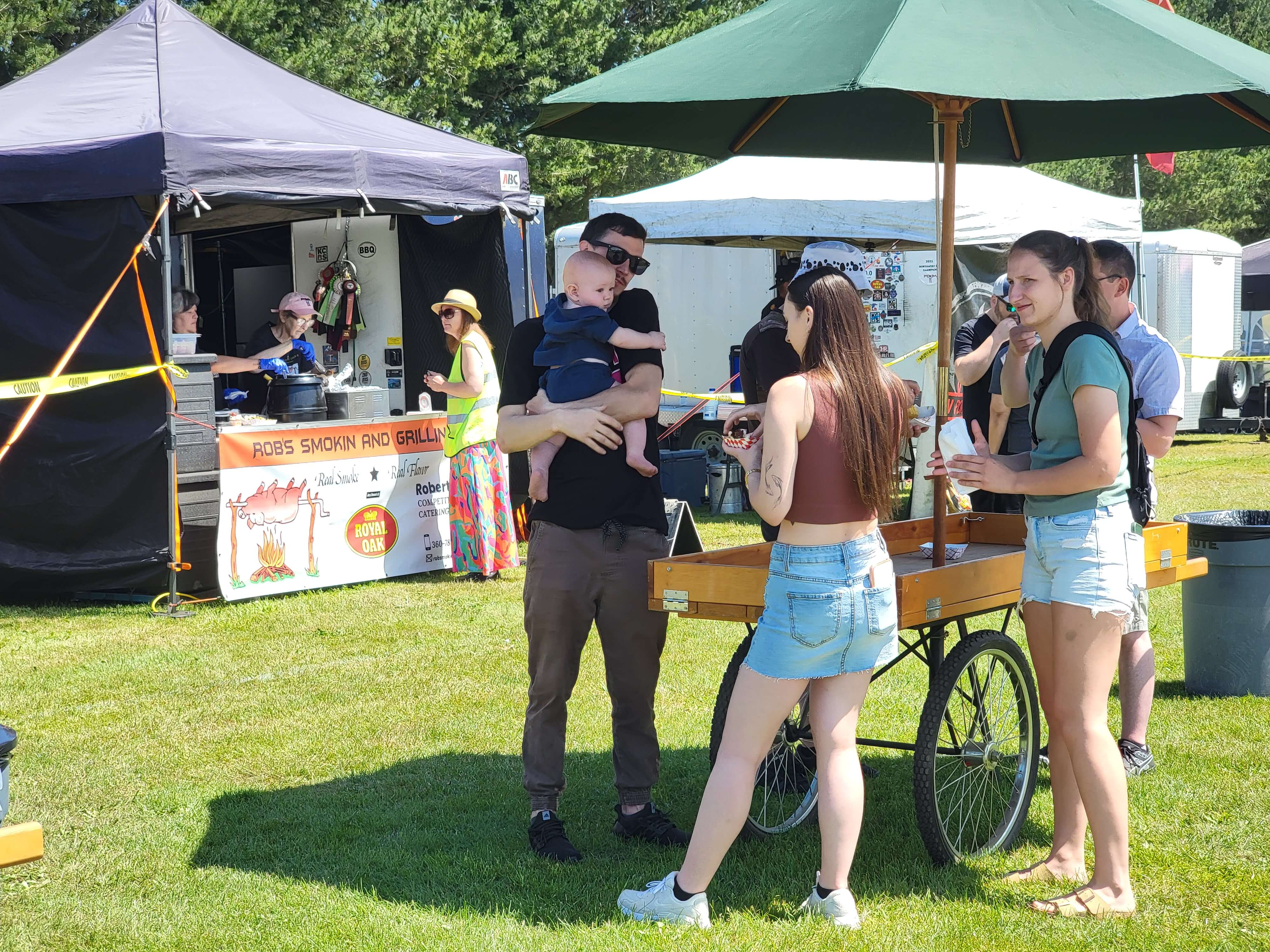 Festival visitors enjoying public BBQ sampling during the Smoke & Grill BBQ Competition at Berry Dairy Days.