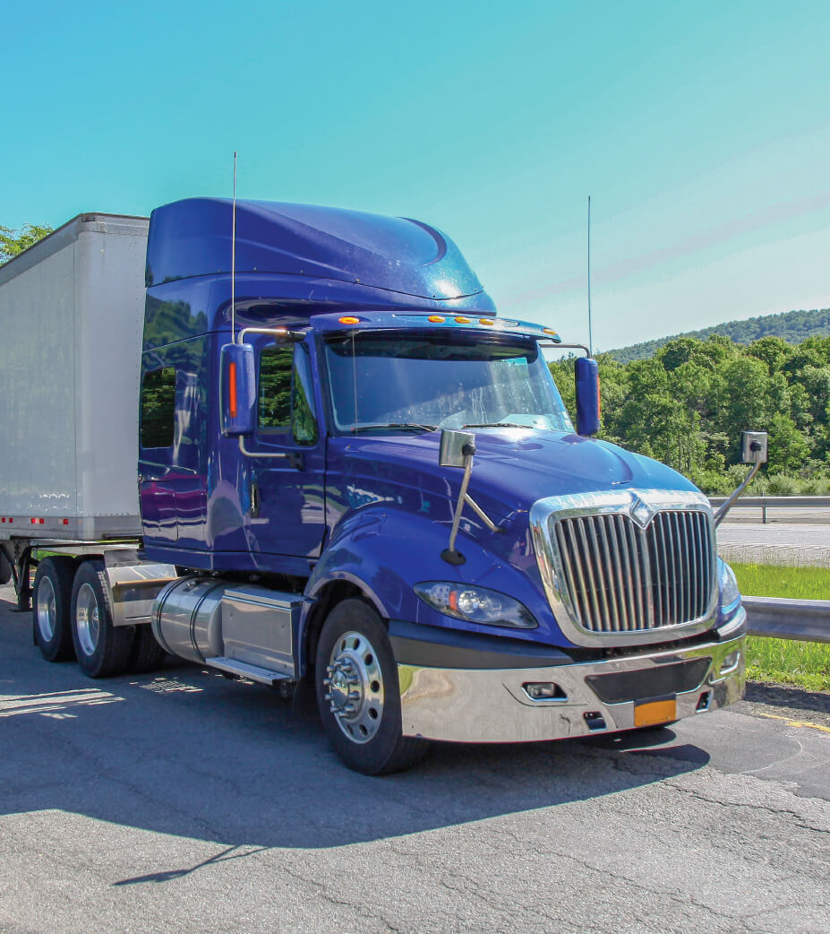 A Blue Semi Truck on the road