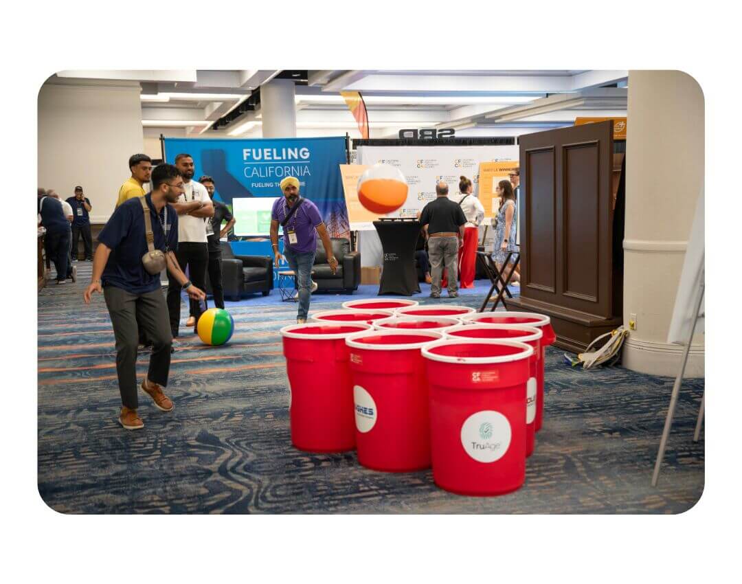 Man Throws beach ball into giant beer pong cups