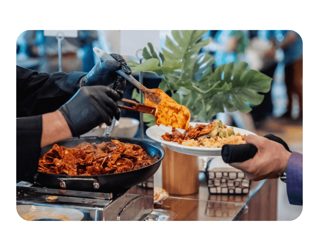 fresh cooked breakfast food being served to someone holding out their plate