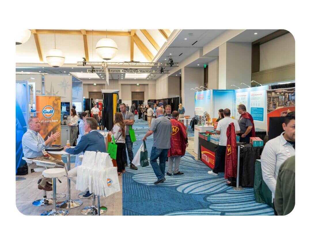 lines of booths and attendees in a trade show exhibit hall