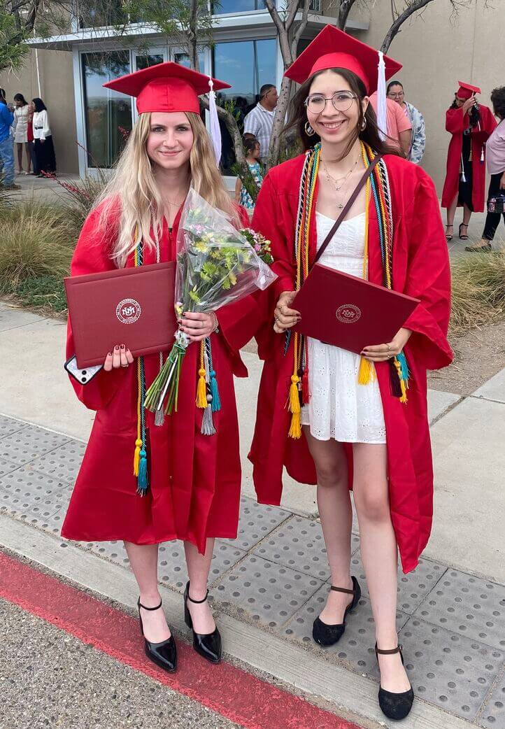 Lifke graduation Lily Alexander (left) and Lauren Lifke (right) stand together wearing caps and gowns for their journalism school graduation in May 2025.