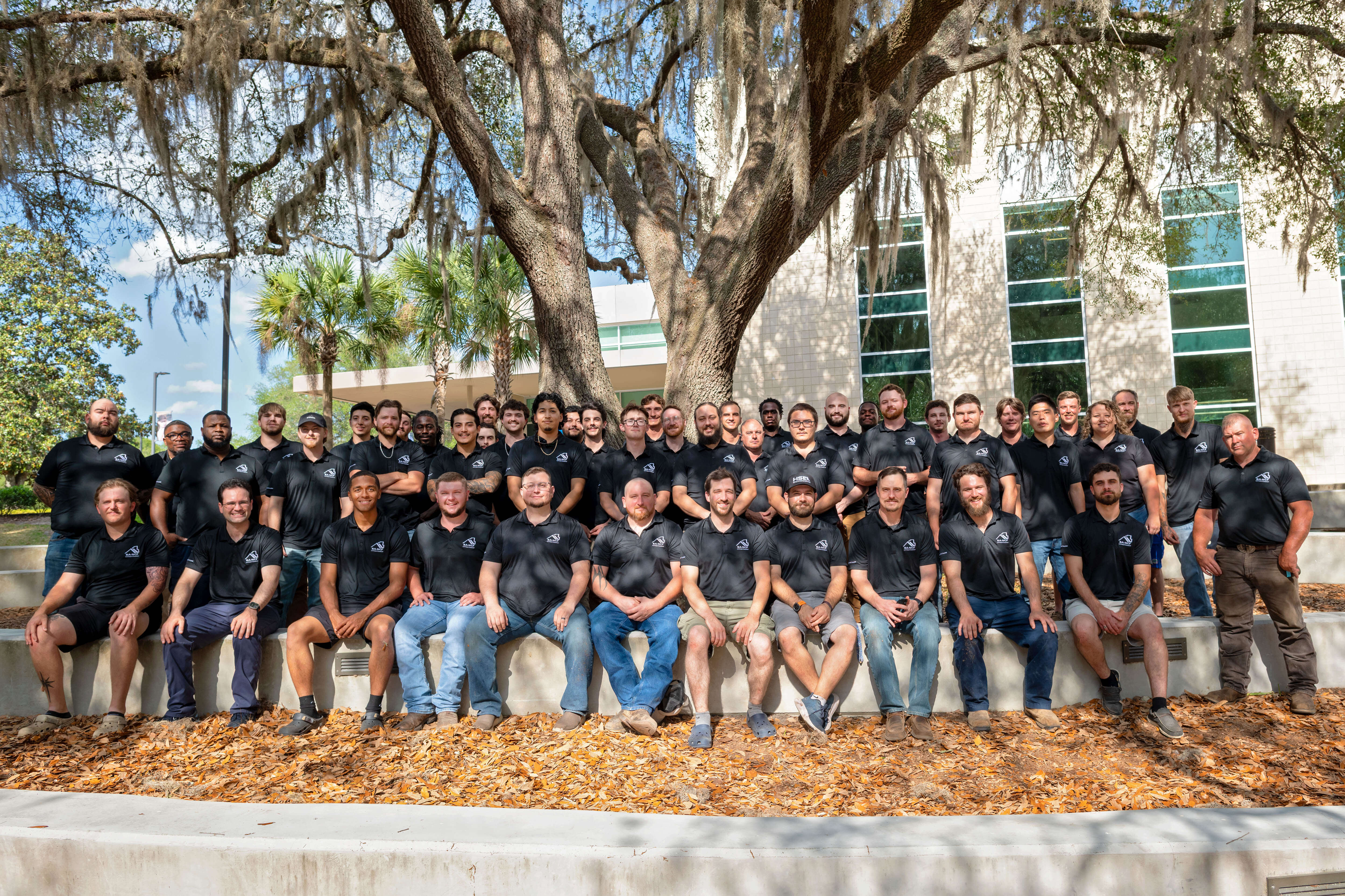 2026 BANCF Graduate Apprentice Program participants gathered for a group photo outside under an oak tree.