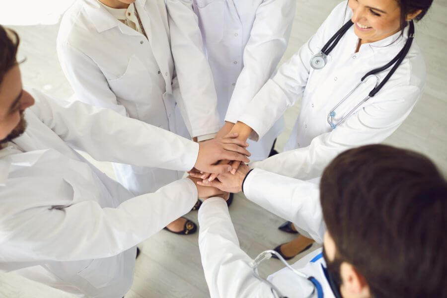 alsam doctors hands in together