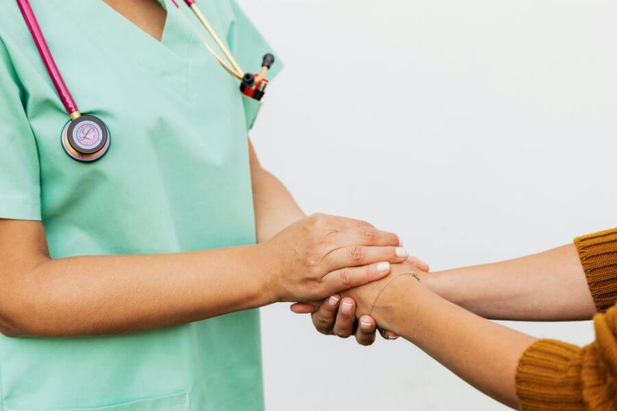 nurse holding patient hands