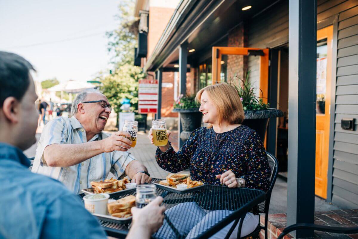 people eating food and raising glasses together