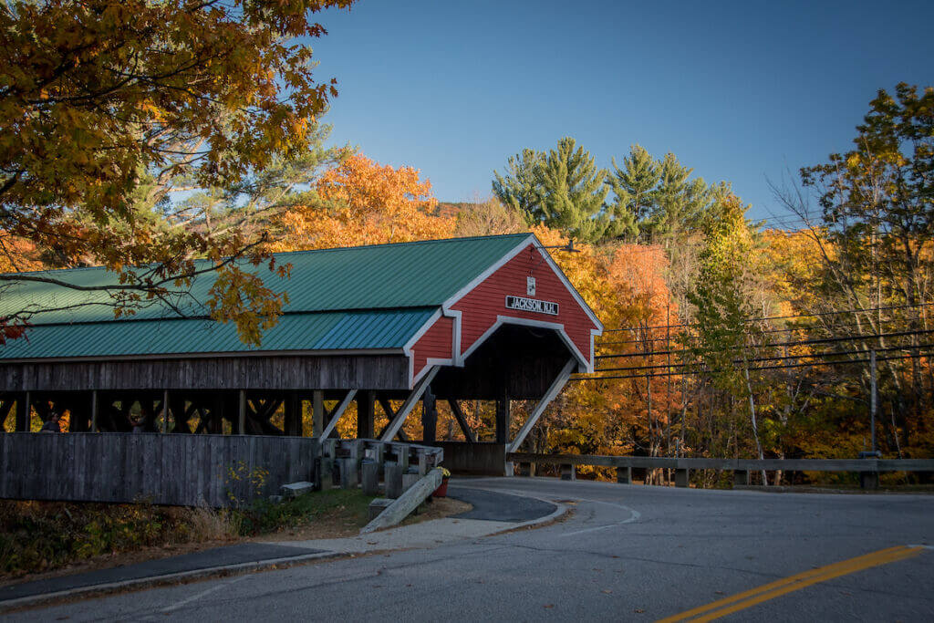 Jackson Covered Bridge in fall surrounded by yellow leaves on the trees.