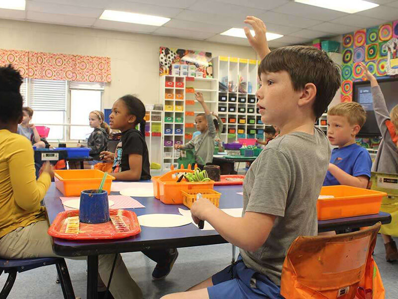 education2 kids raising their hands