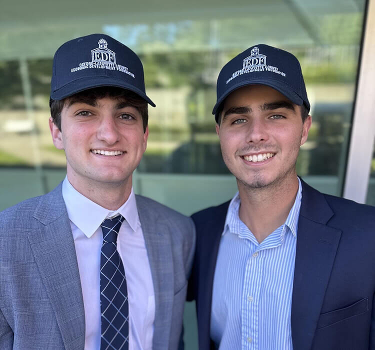 Two young men in OLEDF hats