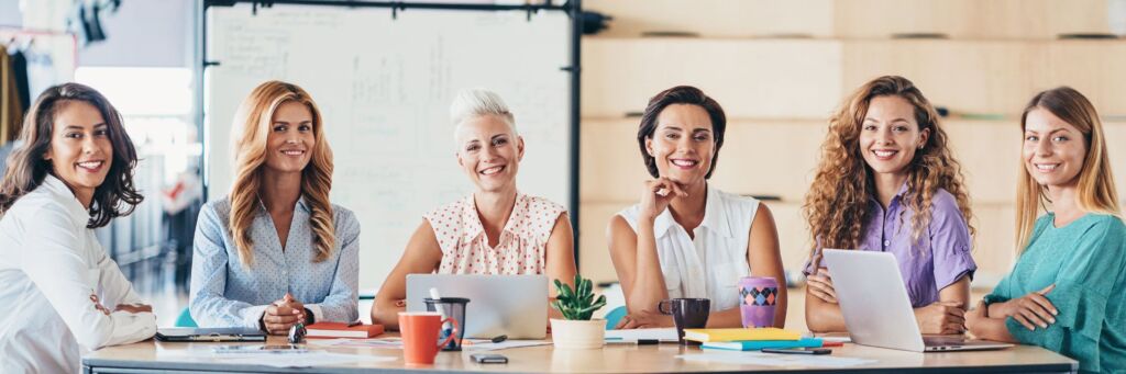 6 business women seated at table