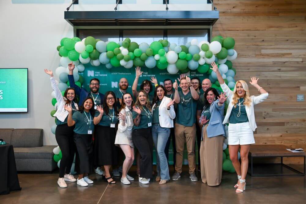 group photo with balloon arch