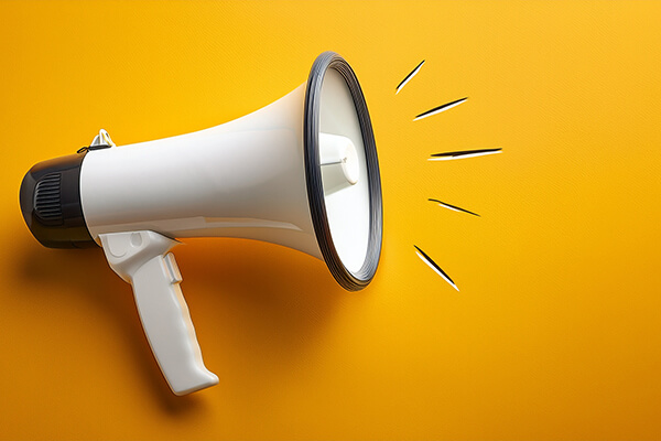 Bullhorn on the bright yellow background representing Marketing Concept