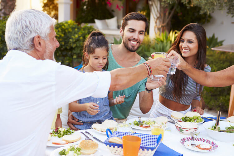 family eating at a table outdoors