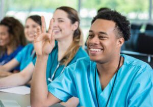 med student raising hand