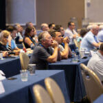 audience listening to speaker
