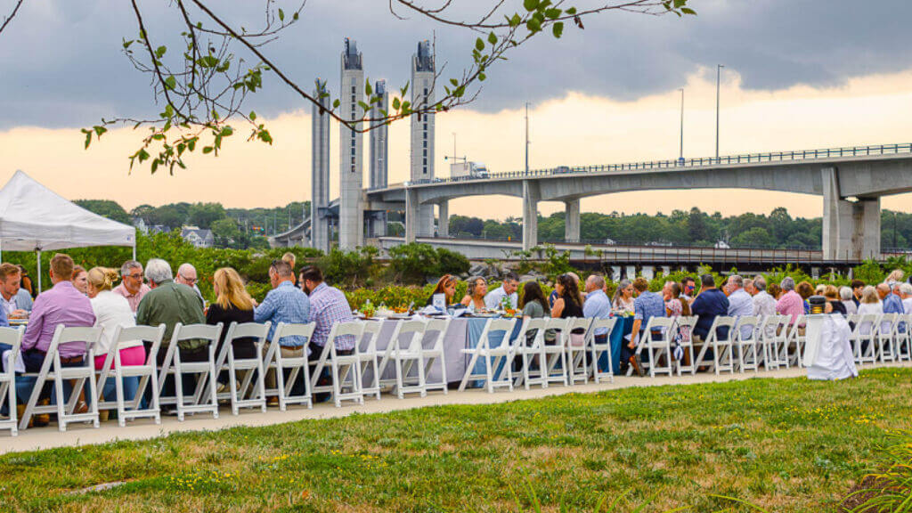 group photo seated at long outdoor table