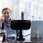 Event participant giving a thumbs up at the check-in kiosk