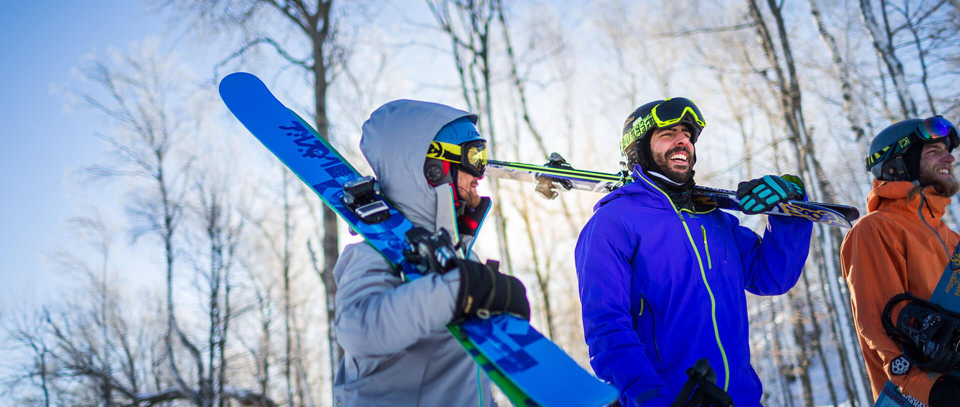 skiers carrying skis on shoulders