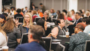 Members gathering around tables having discussions