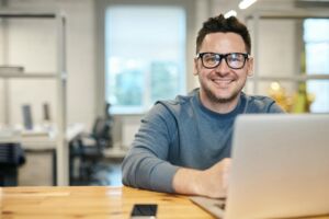 Man smiling at laptop