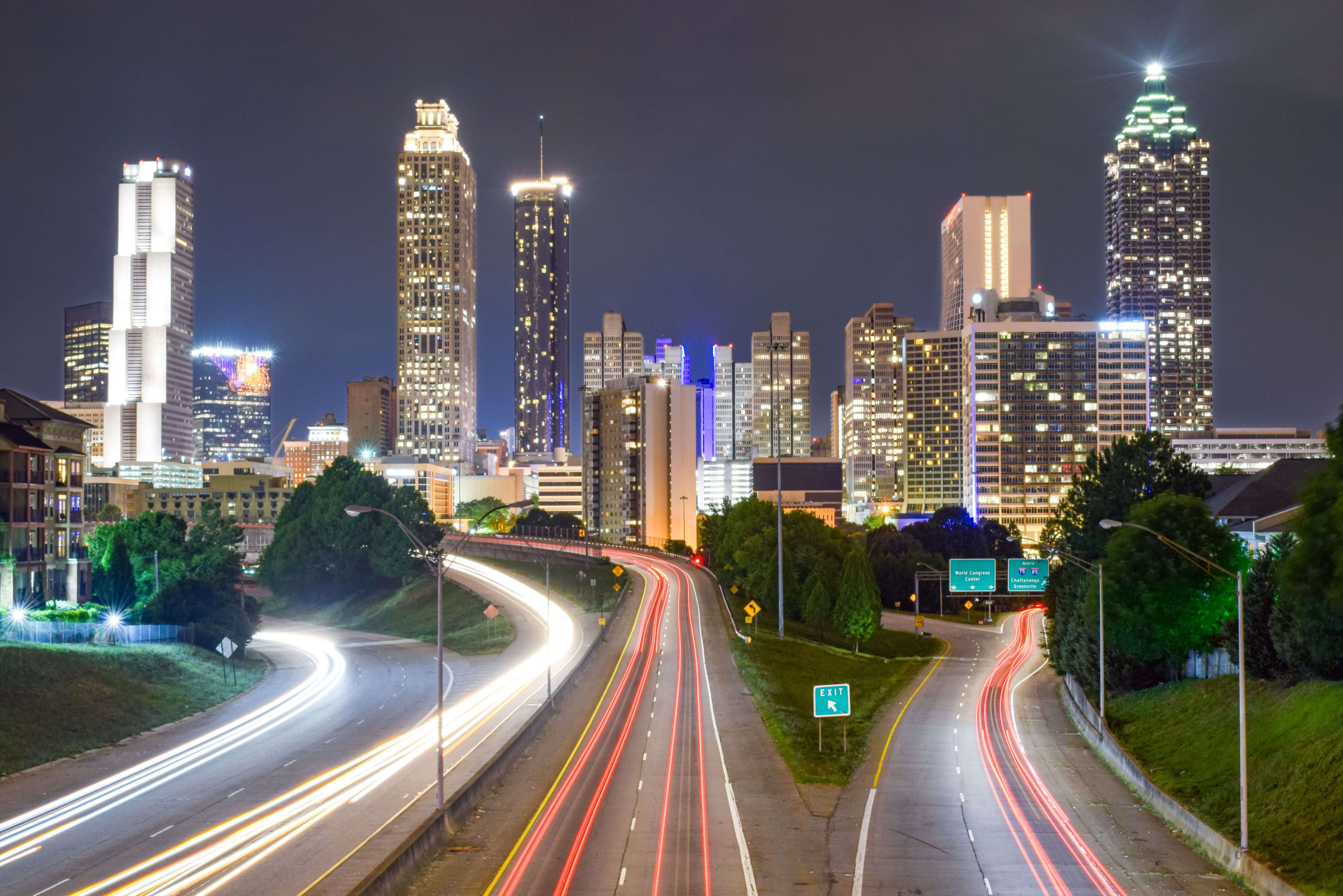 Atlanta skyline at night with traffic blurred
