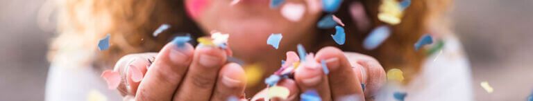 woman blowing confetti