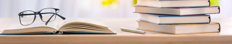 employee handbook with glasses on table