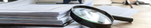 magnifying glass on papers