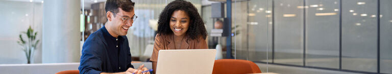 team members on computer in breakroom