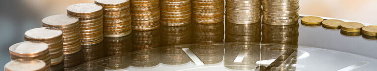 stacks of coins on the edge of a clock
