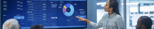 woman presenting graphics to in meeting