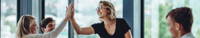 women high fiving at work