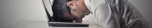 head on computer frustrated