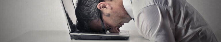 head on computer frustrated