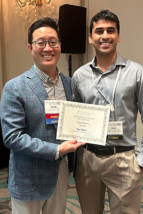 IMG_1968_poster-1st_web two men holding a certificate at annual conference