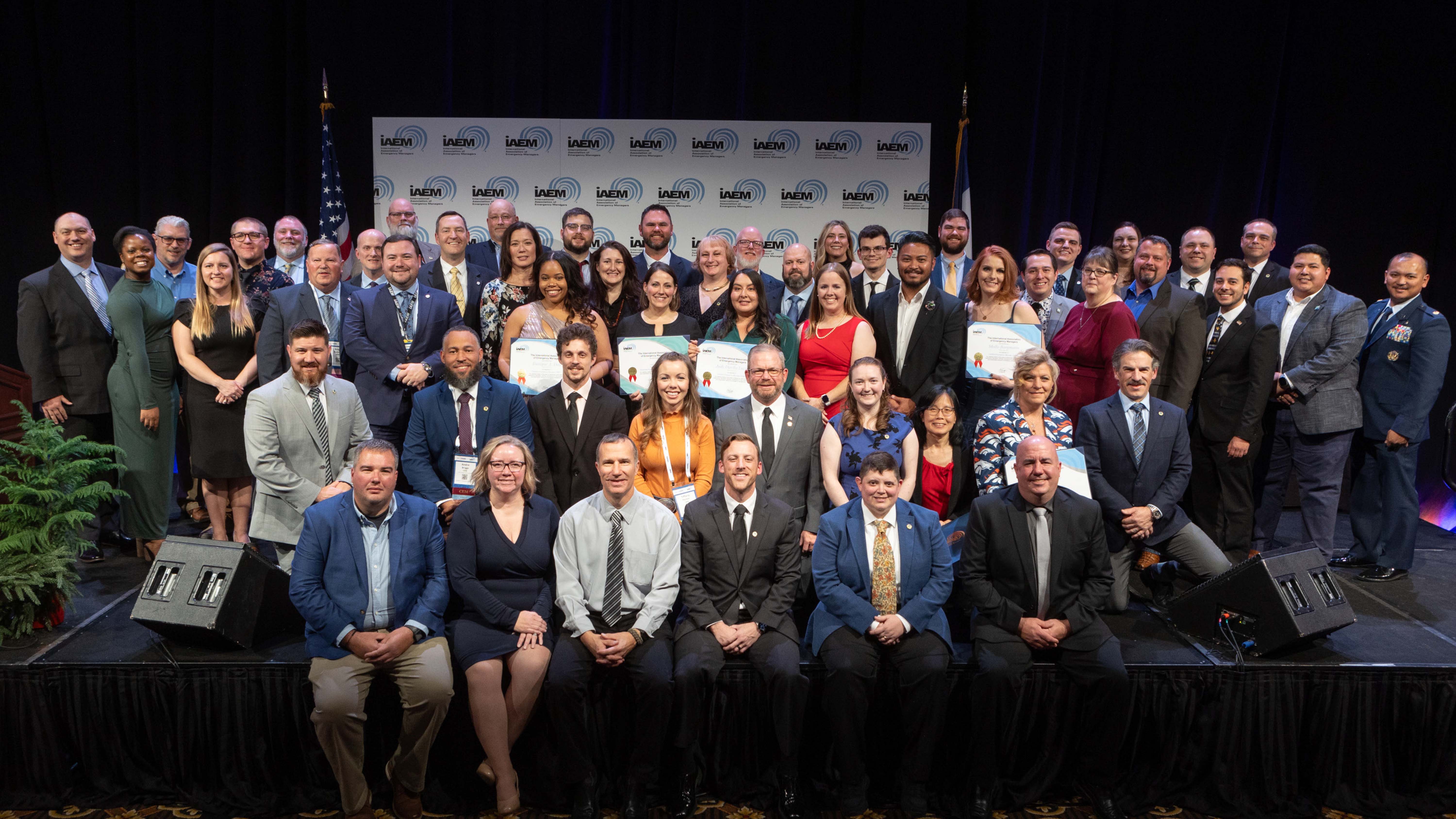 group of professionals posing on stage