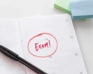 word exam circled on paper