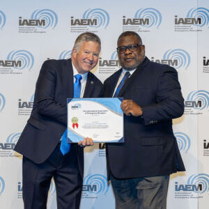 two men holding certifications