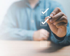 First-Step-To-Certify man checking off boxes overlayed on the screen