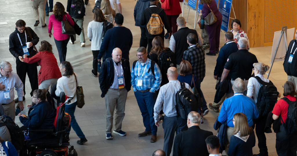 History of IAEM Page_1 people at convention talking