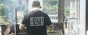 Chef grilling outdoors at Ruse for the Field and Tide Culinary Festival at The Wildset in St. Michaels MD
