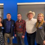 5 people standing for group photo