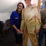 women next to elvis cutout