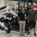 three men next to machinery