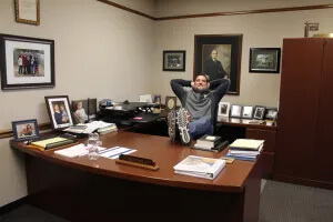 man with feet up on desk