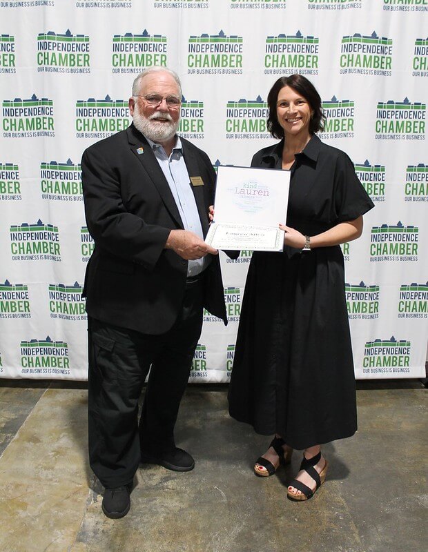 two people holding certificate