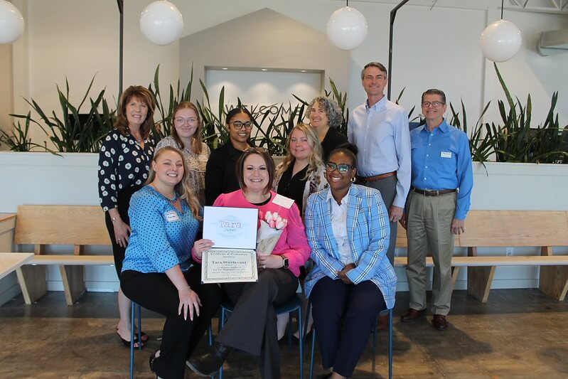 group of people holding certificate