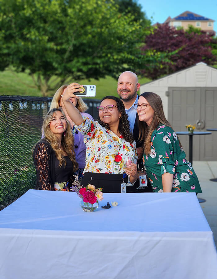 4 people taking a selfie
